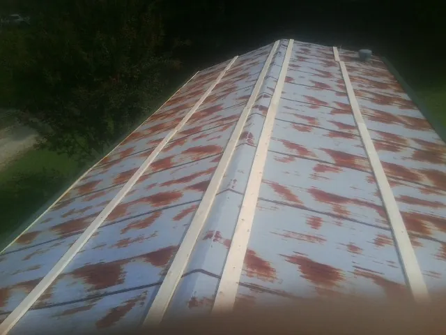 Rusted metal roof panels with new wood purlins before replacement — Storm Damage Roof Repair in Macungie by Roofing Brothers