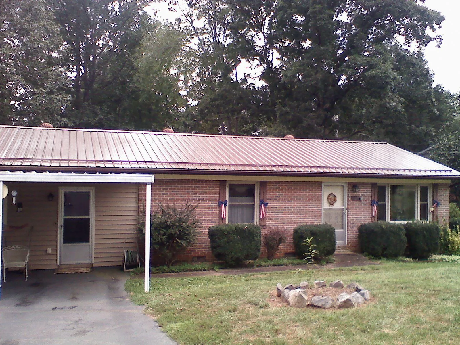 Bronze metal roof and carport on a brick ranch home — Roof Repair work by our crew in Macungie