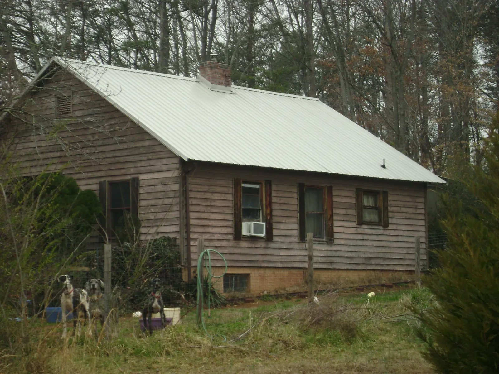 White metal roof on an old wood sided farmhouse, from a Metal Roof Installation job in Macungie